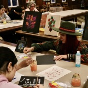 Artist Marina Malyarenko and students painting at the "Voices of Freedom, Voices of War in Ukraine: Readings and Conversations" event.