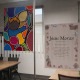On the left is an artwork by Jesus Moran with brightly colored circles and ovals. On the right is the artist statement: "'Amor eterno': A mother hugging new born. A symbol of first love and everything Women/Mothers go through in order for their children to be successful.