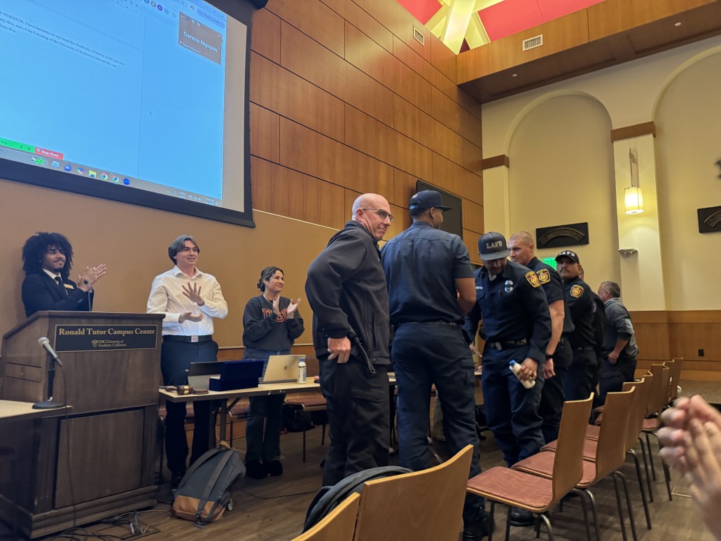 Wildfire first responders stand up to applause.