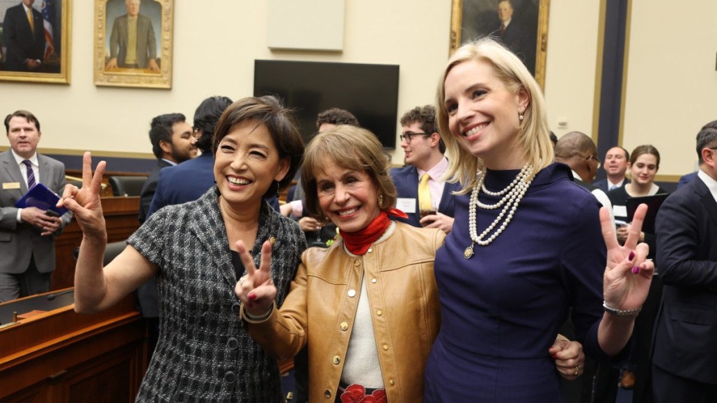 From left to right: Rep. Young Kim, President Carol Folt, and Rep. Sydney Kamlager-Dove smile for a photo and make the "Fight on" hand sign.
