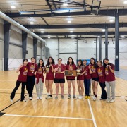 Members of the Trojan Fencing Club pose with their medals, plaques, and trophies