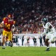 Redshirt junior quarterback Jayden Maiava stares down a Michigan State player as he runs past.