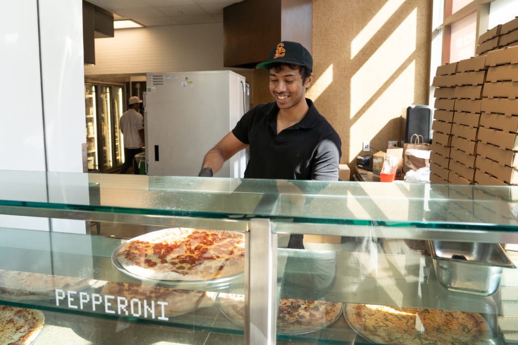 Hospitality staff in TCC (Mallory Snyder / Daily Trojan) TCC staff preparing to serve pizza.