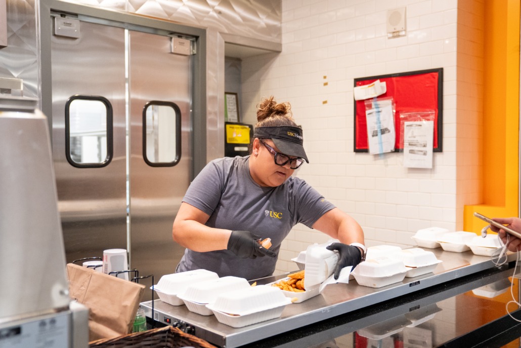 Hospitality staff in TCC (Mallory Snyder / Daily Trojan) TCC staff packing a meal box.