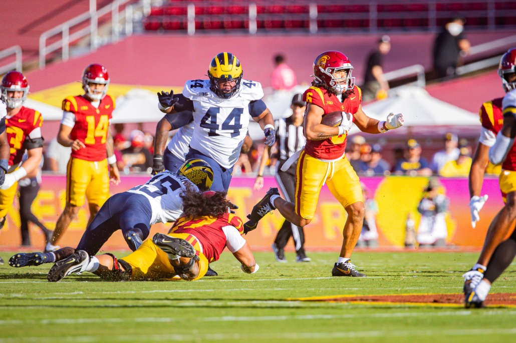 Junior wide receiver Makai Lemon runs away from Michigan defenders.