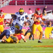 Junior wide receiver Makai Lemon runs away from Michigan defenders.