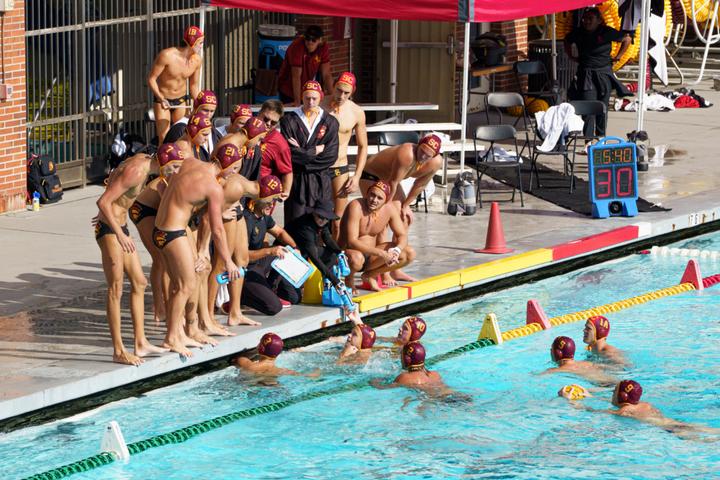 Men's water polo huddles in a timeout