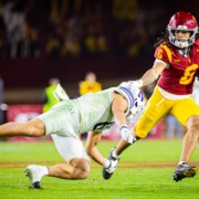 USC junior wide receiver Makai Lemon stiff arms a Northwestern defender.