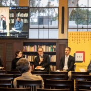Image of inside Mudd Hall with four panelists.