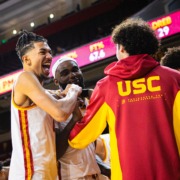 Graduate guard Chad Baker-Mazara celebrates with teammates during a game against Cal Poly.
