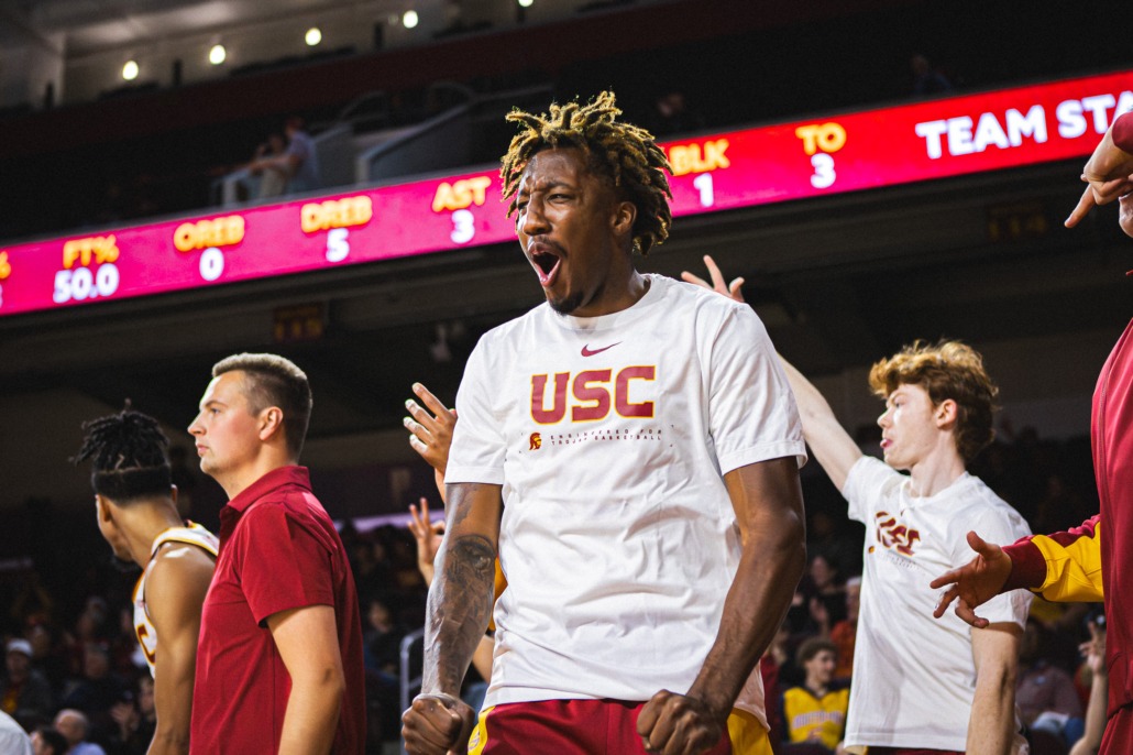 Graduate guard EJ Neal Jr. celebrates from the bench