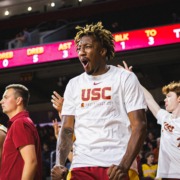 Graduate guard EJ Neal Jr. celebrates from the bench