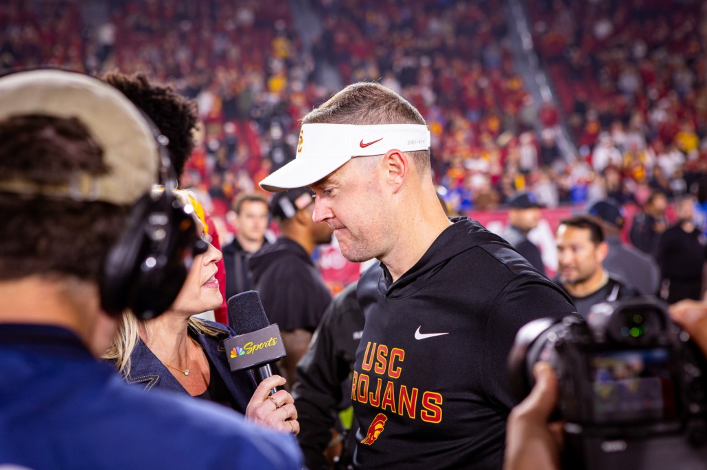 Lincoln Riley talks to reporters during a game against UCLA
