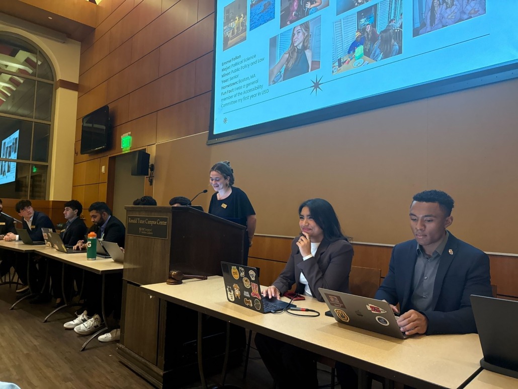 The senate chambers with several senators sitting in the front.