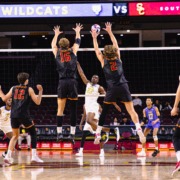 Wesley Smith and Noah Roberts jump to block an opposing spike.