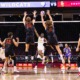Wesley Smith and Noah Roberts jump to block an opposing spike.