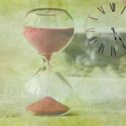 hourglass with sand pouring and clock