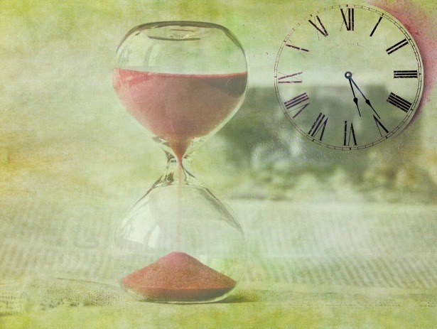 hourglass with sand pouring and clock