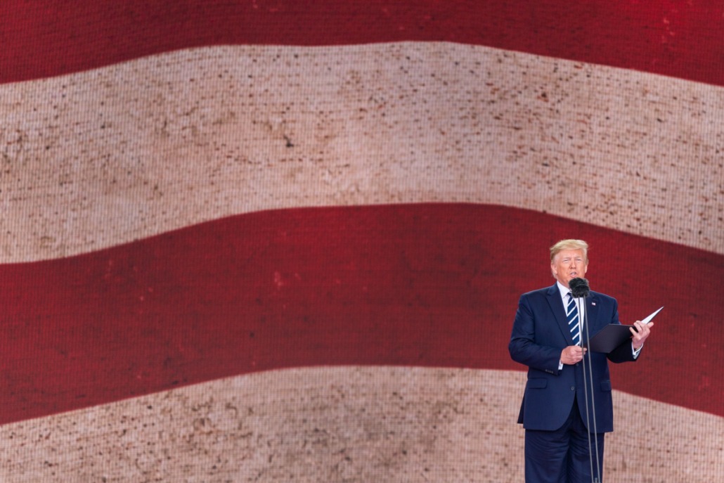 Donald Trump dwarfed by an American flag