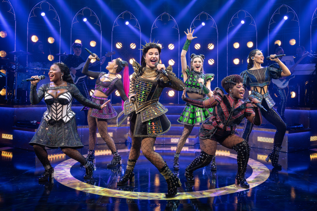 The performers sing together on stage of "SIX the Musical."