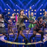 The performers sing together on stage of "SIX the Musical."