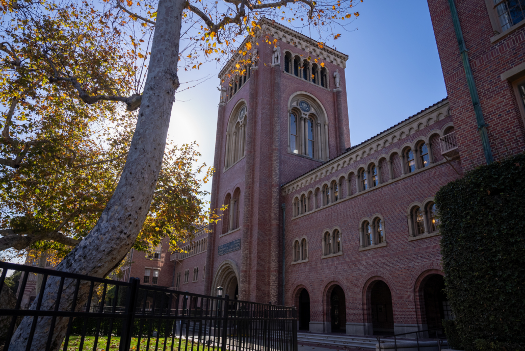 Bovard Auditorium with fencing on the lawn in front