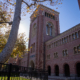 Bovard Auditorium with fencing on the lawn in front