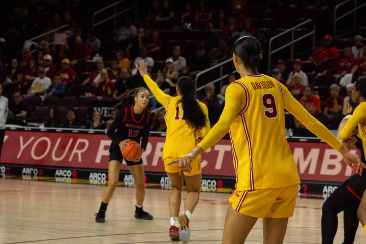 USC women's basketball players defend against Rutgers