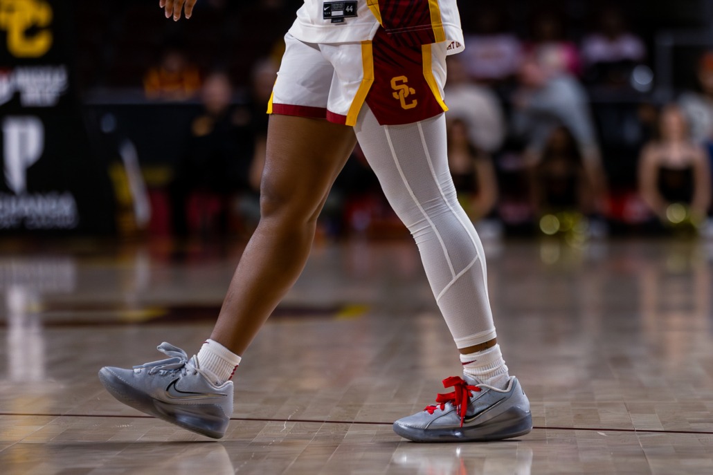 A USC women's basketball player walks on the court in shoes designed by JuJu Watkins