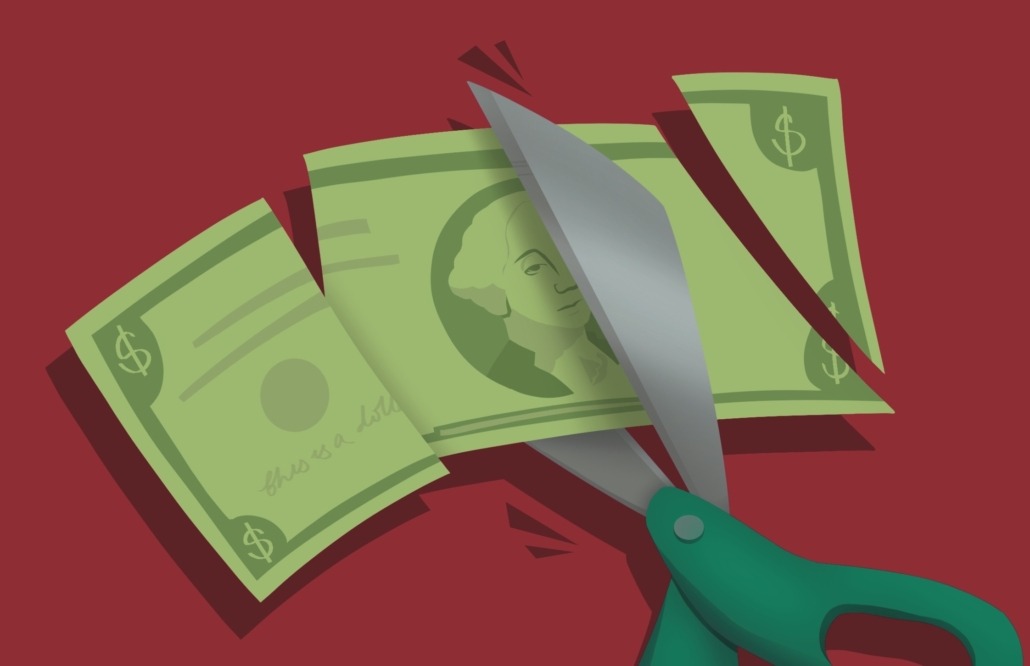 Art of a dollar bill being cut up by scissors.