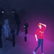 Man walking and wearing shirt that says "no bra" and people standing in background