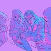 Four young people huddled around a phone