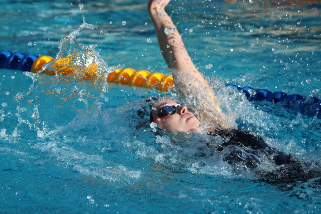 A Trojan swims backstroke