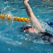 A Trojan swims backstroke