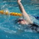 A Trojan swims backstroke