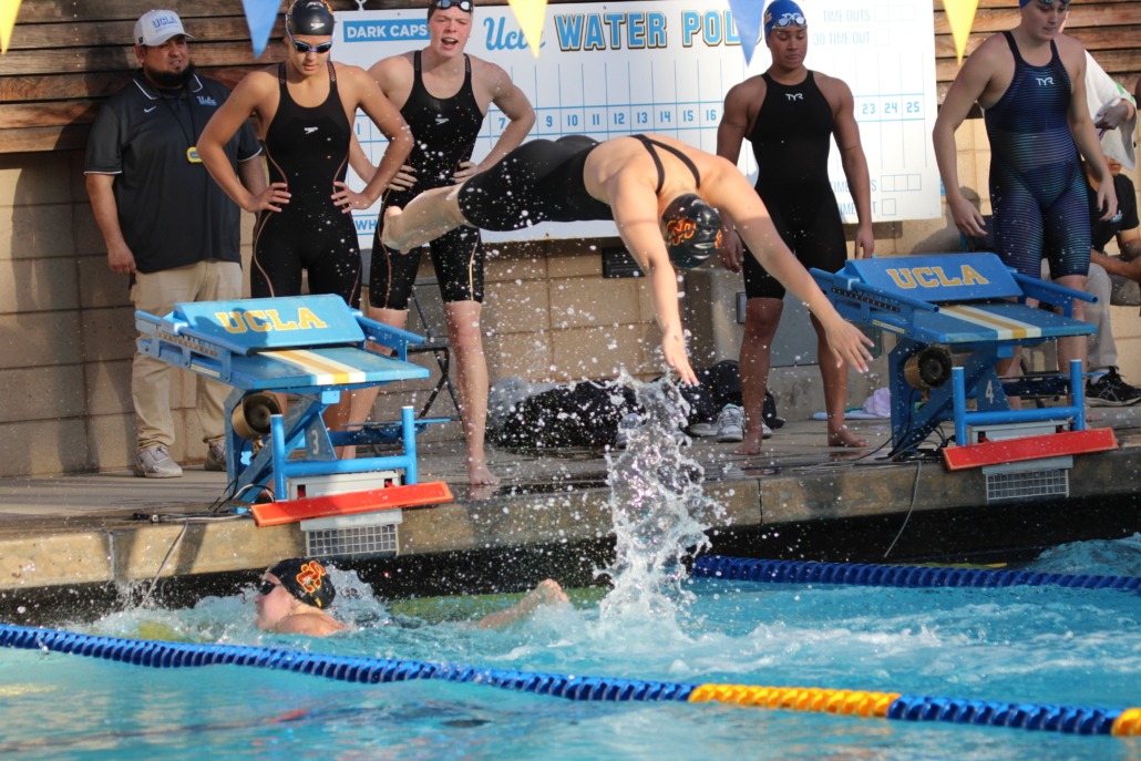 USC swimmers exchange at the wall during a relay