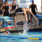 USC swimmers exchange at the wall during a relay