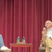 Filmmaker James Ivory sits in a chair on stage during a Q&A at the USC School of Cinematic Arts.