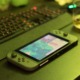 A green Nintendo Switch with Stardew Valley playing sits on a green table.