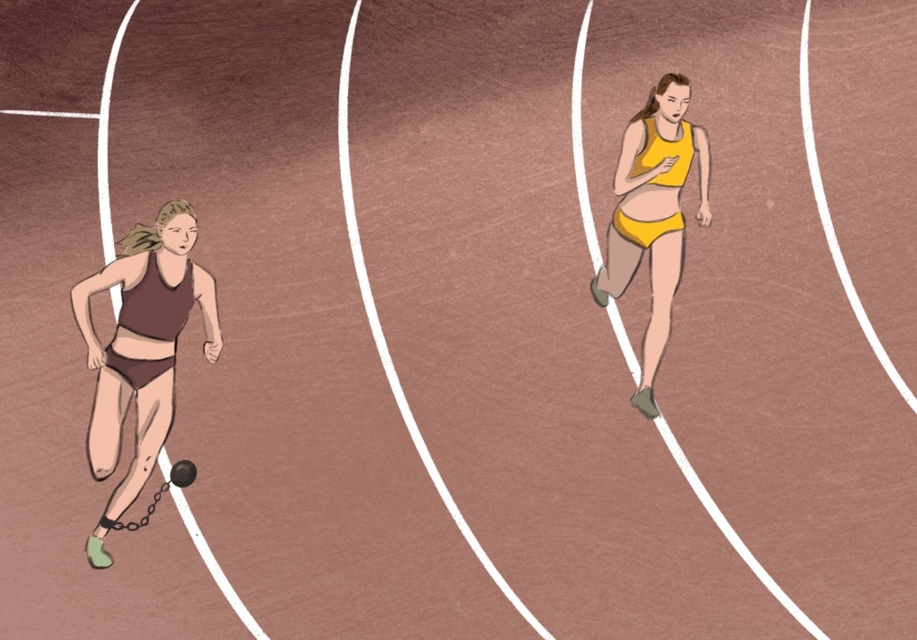 Two women racing on a racetrack, one of them has a weight attached to her leg