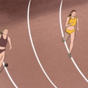 Two women racing on a racetrack, one of them has a weight attached to her leg