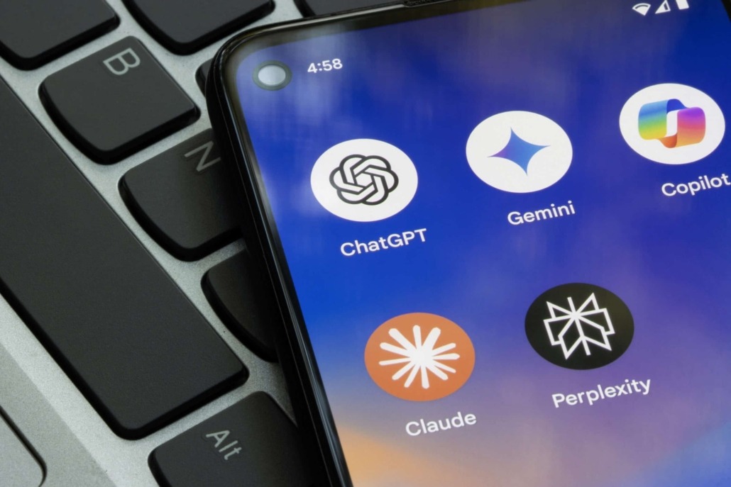 A phone with multiple AI apps laying on a keyboard.