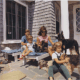 color photo of the Kennedy family playing with their dogs
