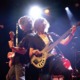 A guitarist and a bass player play together onstage at the pop showcase.