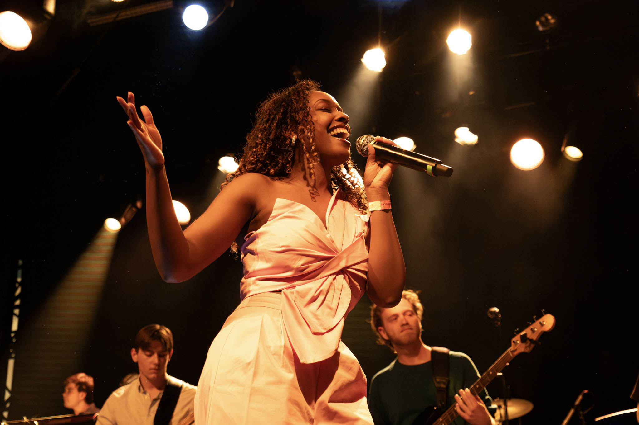 A singer performs on stage at the pop showcase.