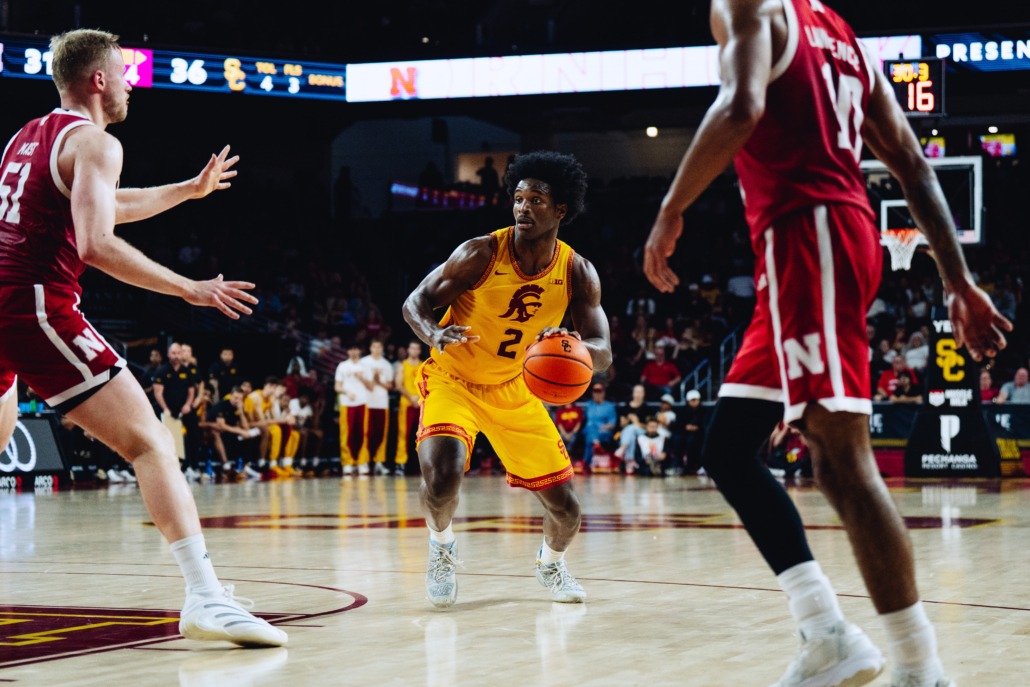 Ezra Ausar dribbles the ball near the rim