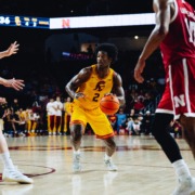 Ezra Ausar dribbles the ball near the rim