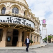 Warner Brothers lot with a man in a suit walking away