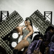Cardi B performs on stage wearing a silver bodysuit.