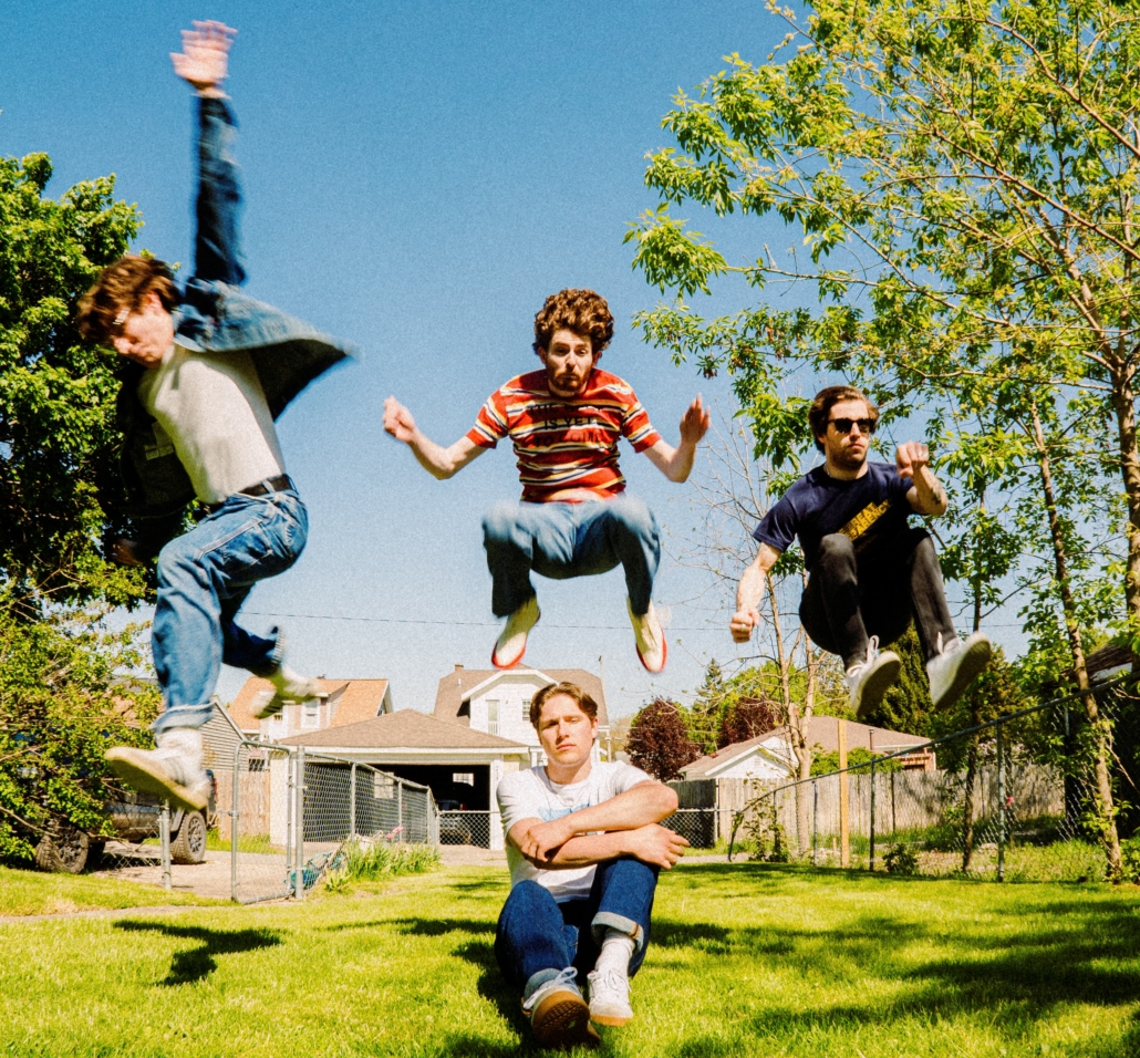 The band members of Pretoria posing in the air.